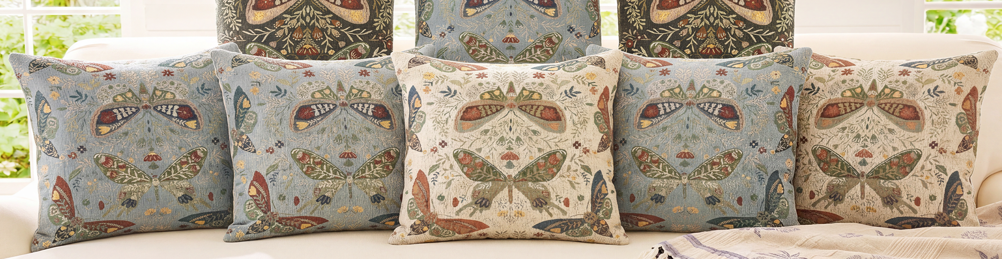 Cozy living room styled with woven patterned pillows and throw blankets from Infin8 Mercantile