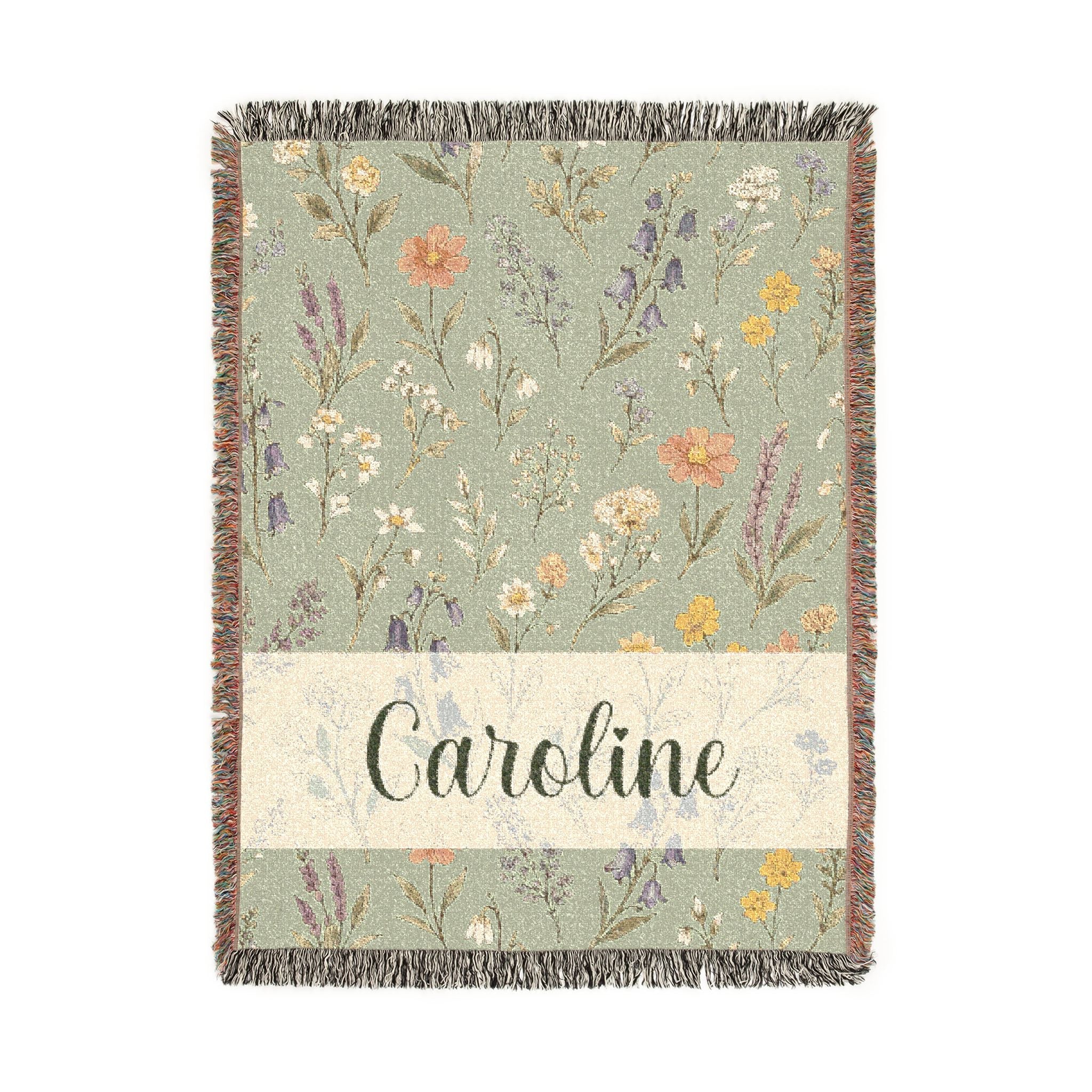 Floral patterned throw blanket with 'Caroline' text on a white background