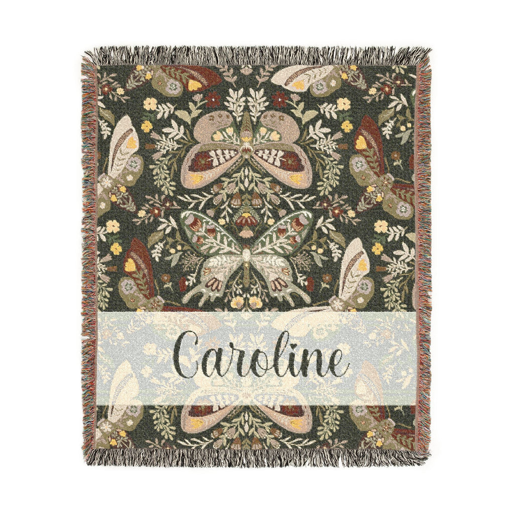 Decorative blanket with butterfly pattern and 'Caroline' text on a white background