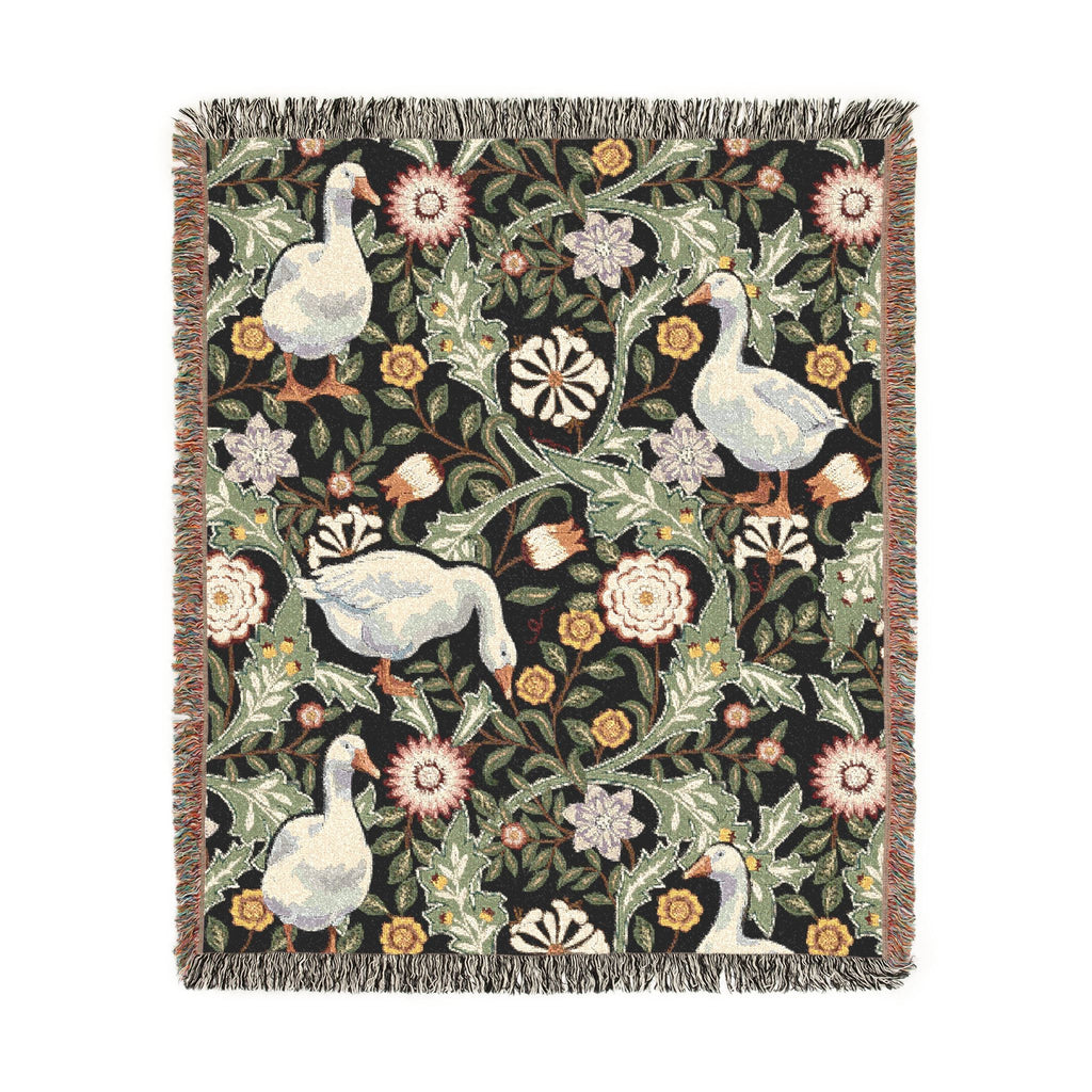 Decorative blanket with floral and geese pattern on a white background