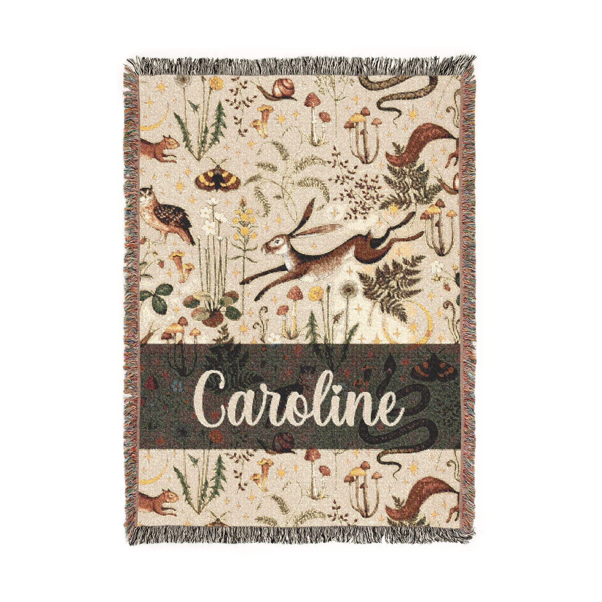 Decorative throw blanket with animal patterns and the name 'Caroline' on a white background