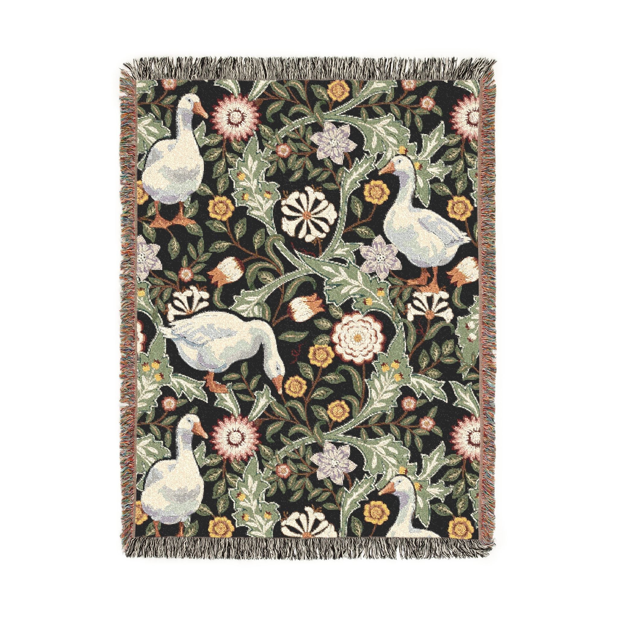 Decorative blanket with floral and geese pattern on a white background