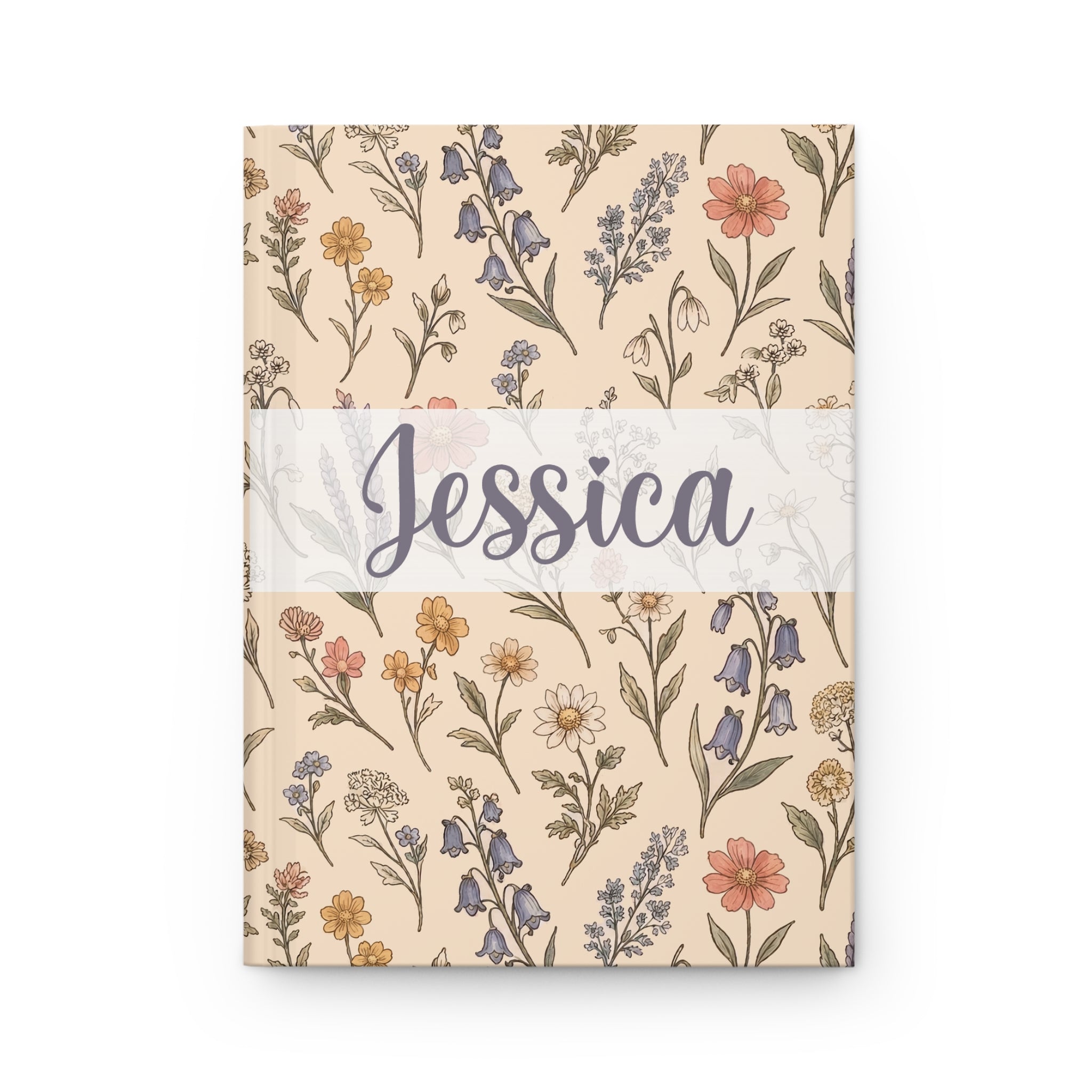Notebook with floral pattern and 'Jessica' on a beige background