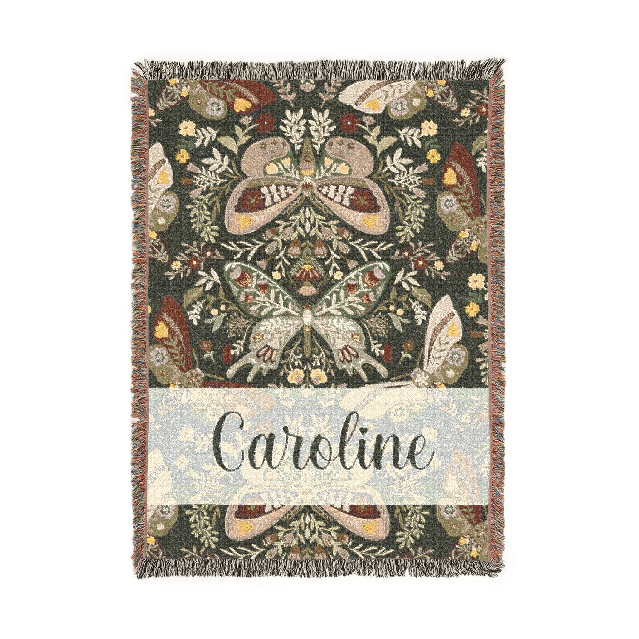 Decorative blanket with butterfly pattern and 'Caroline' text on a white background