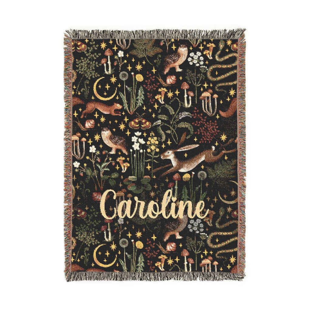 Decorative blanket with nature-themed design and 'Caroline' text on a white background