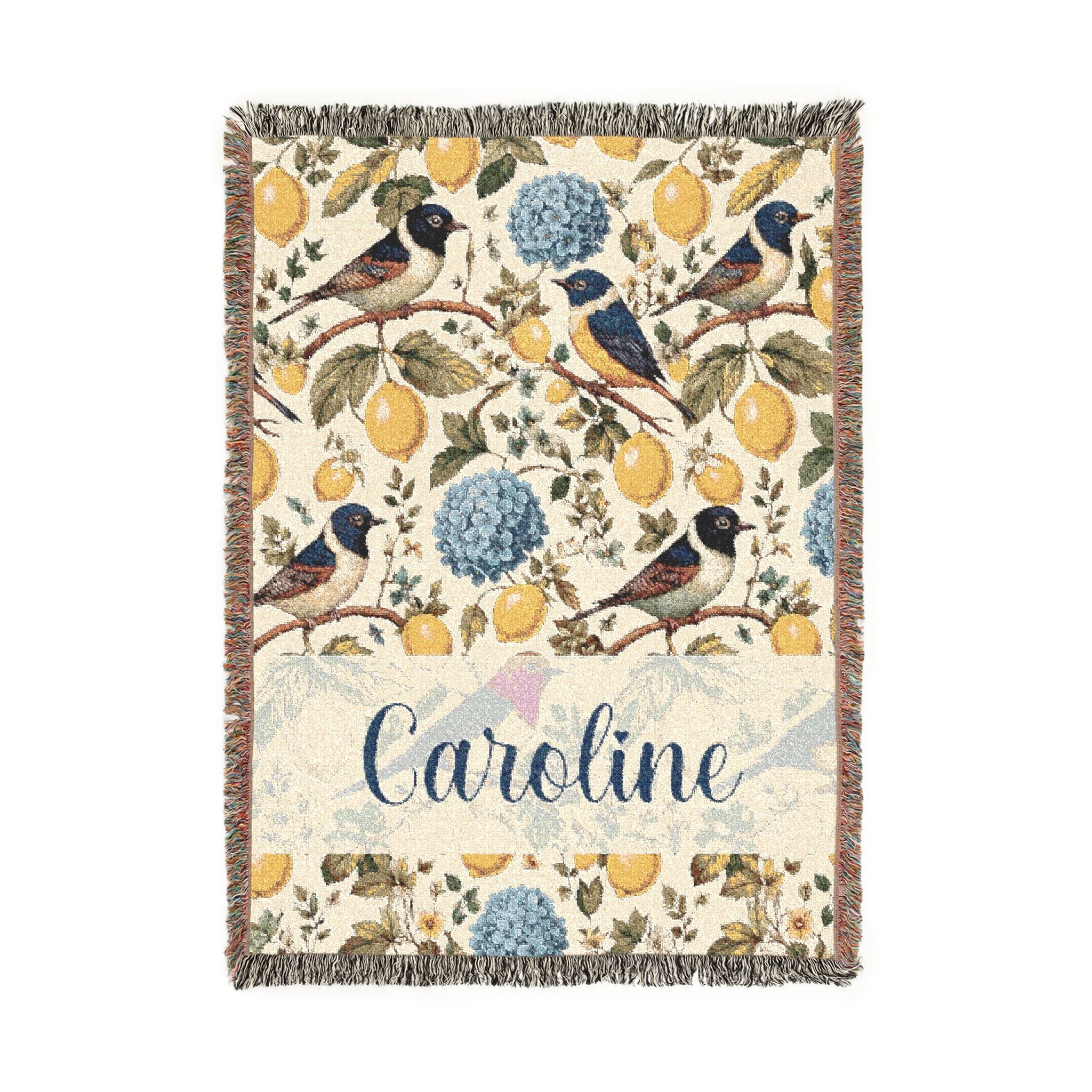 Floral and bird patterned throw blanket with the name 'Caroline' on a white background