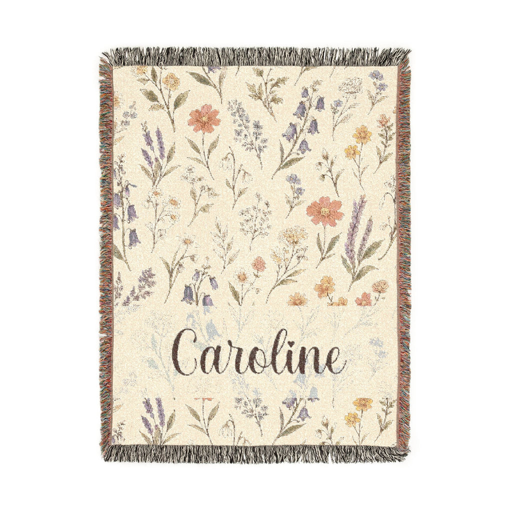 Floral patterned throw blanket with 'Caroline' text on a white background