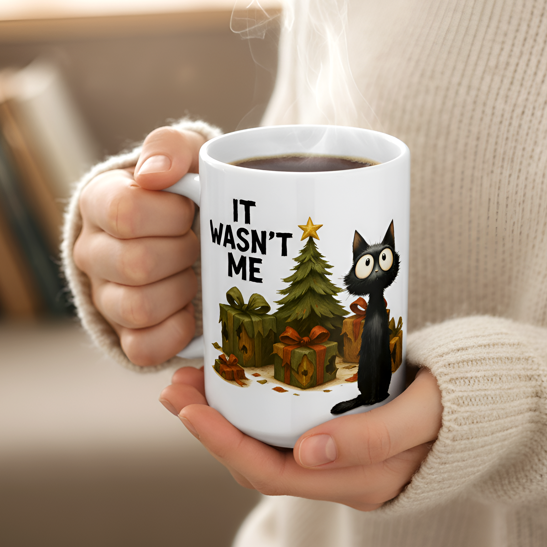 Person holding a mug with a black cat and Christmas tree design, text 'IT WASN'T ME'.