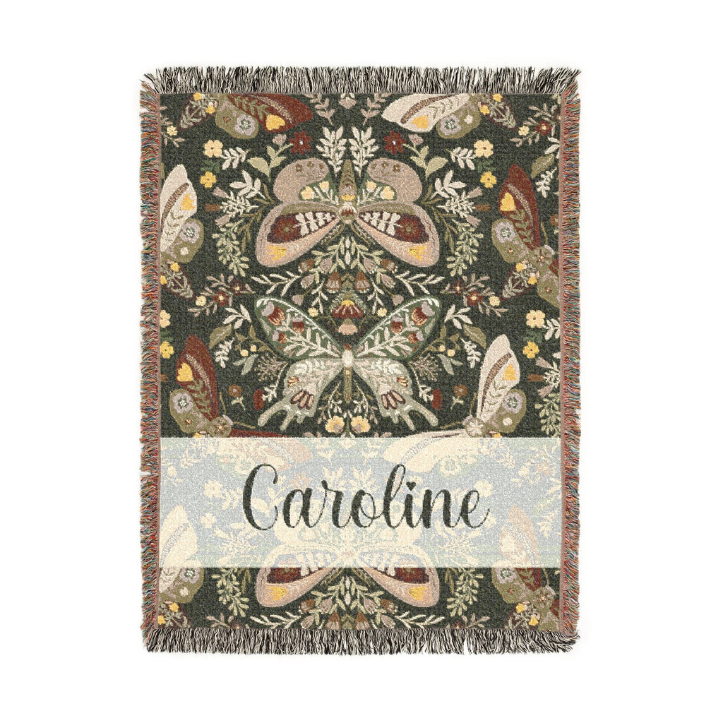 Decorative blanket with butterfly pattern and 'Caroline' text on a white background