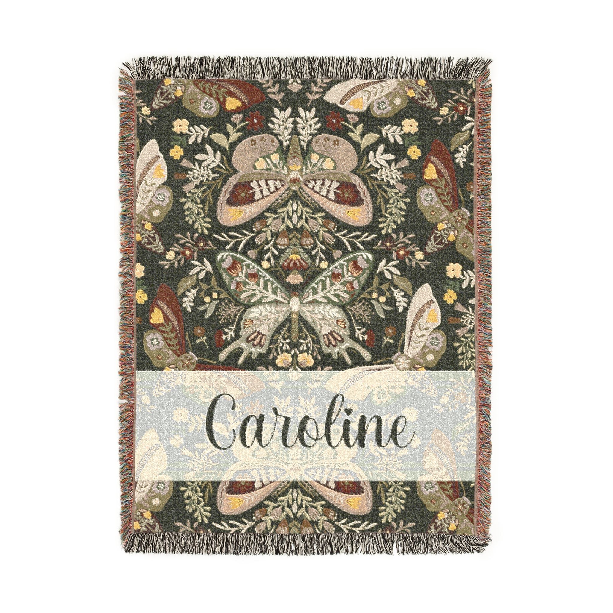 Decorative blanket with butterfly pattern and 'Caroline' text on a white background