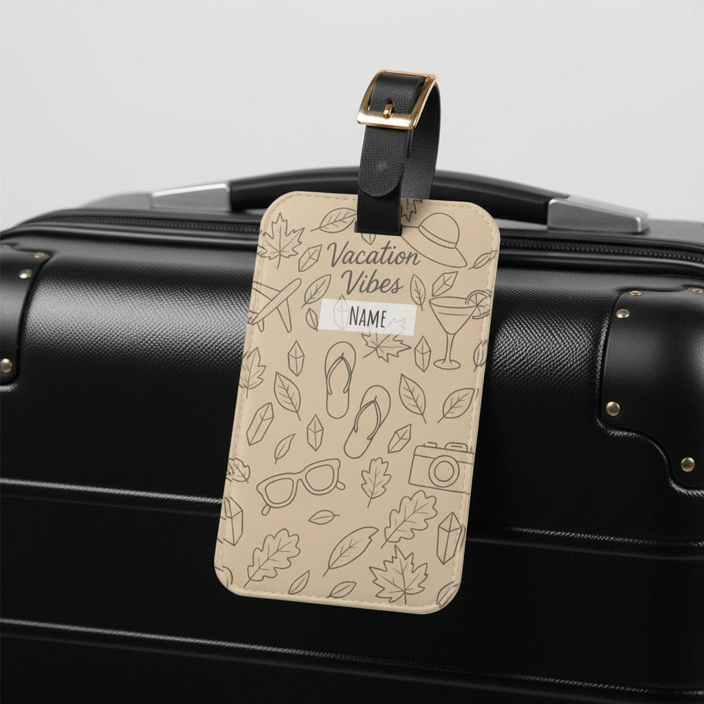 Beige luggage tag with travel-themed design and 'Vacation Vibes' text on a white background