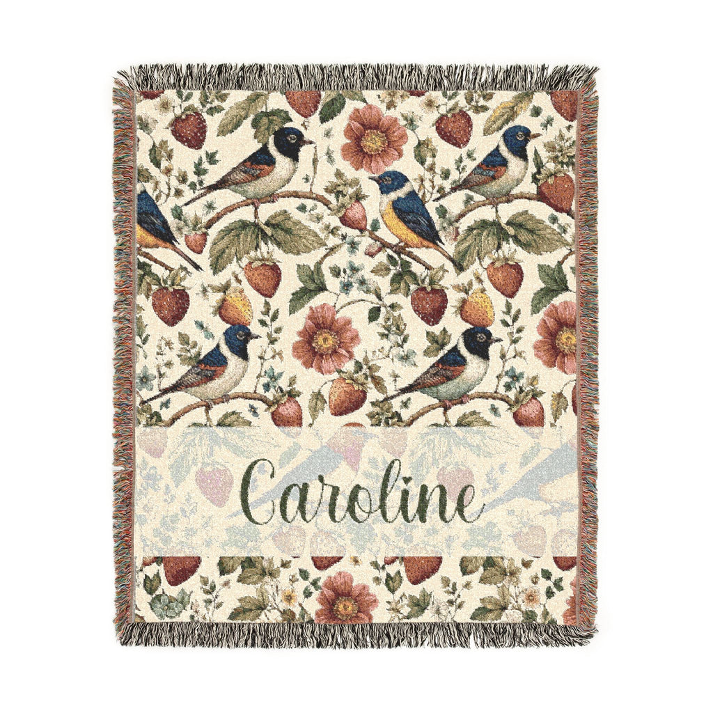 Floral and bird patterned throw blanket with 'Caroline' text on a white background