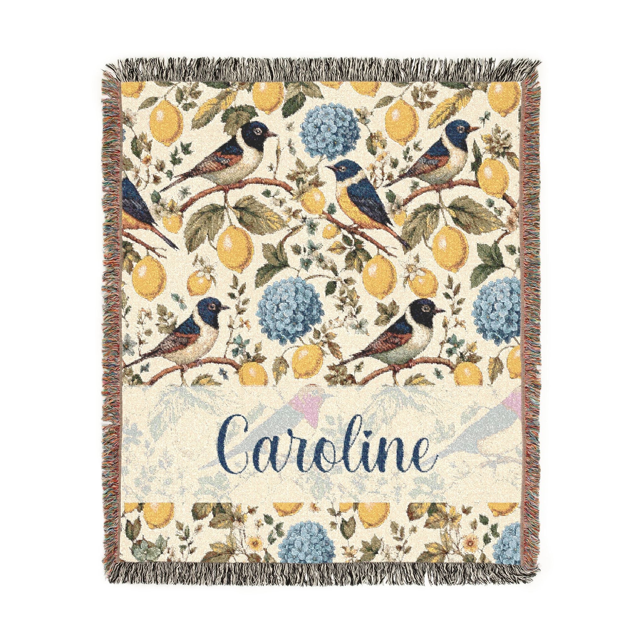 Decorative blanket with floral and bird pattern and the name 'Caroline' on a white background