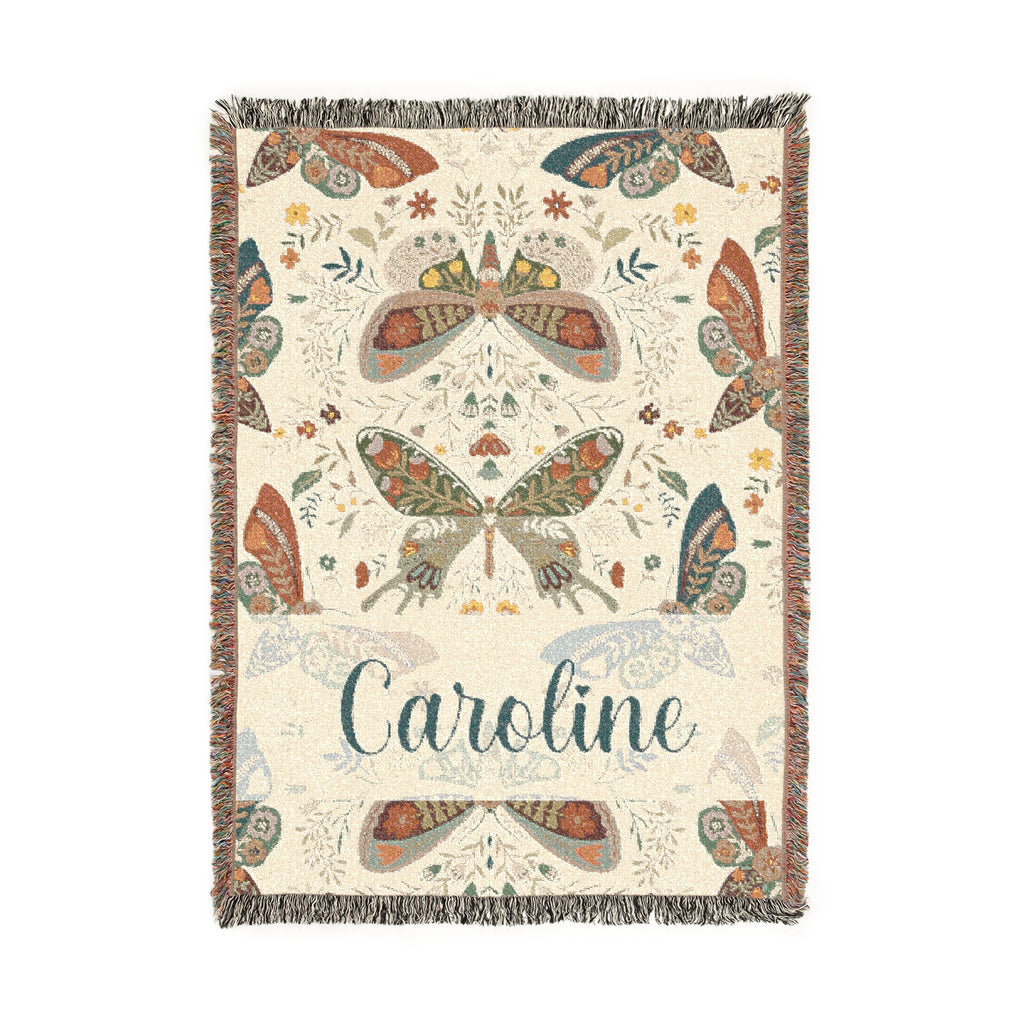 Decorative blanket with butterfly patterns and the name 'Caroline' on a white background