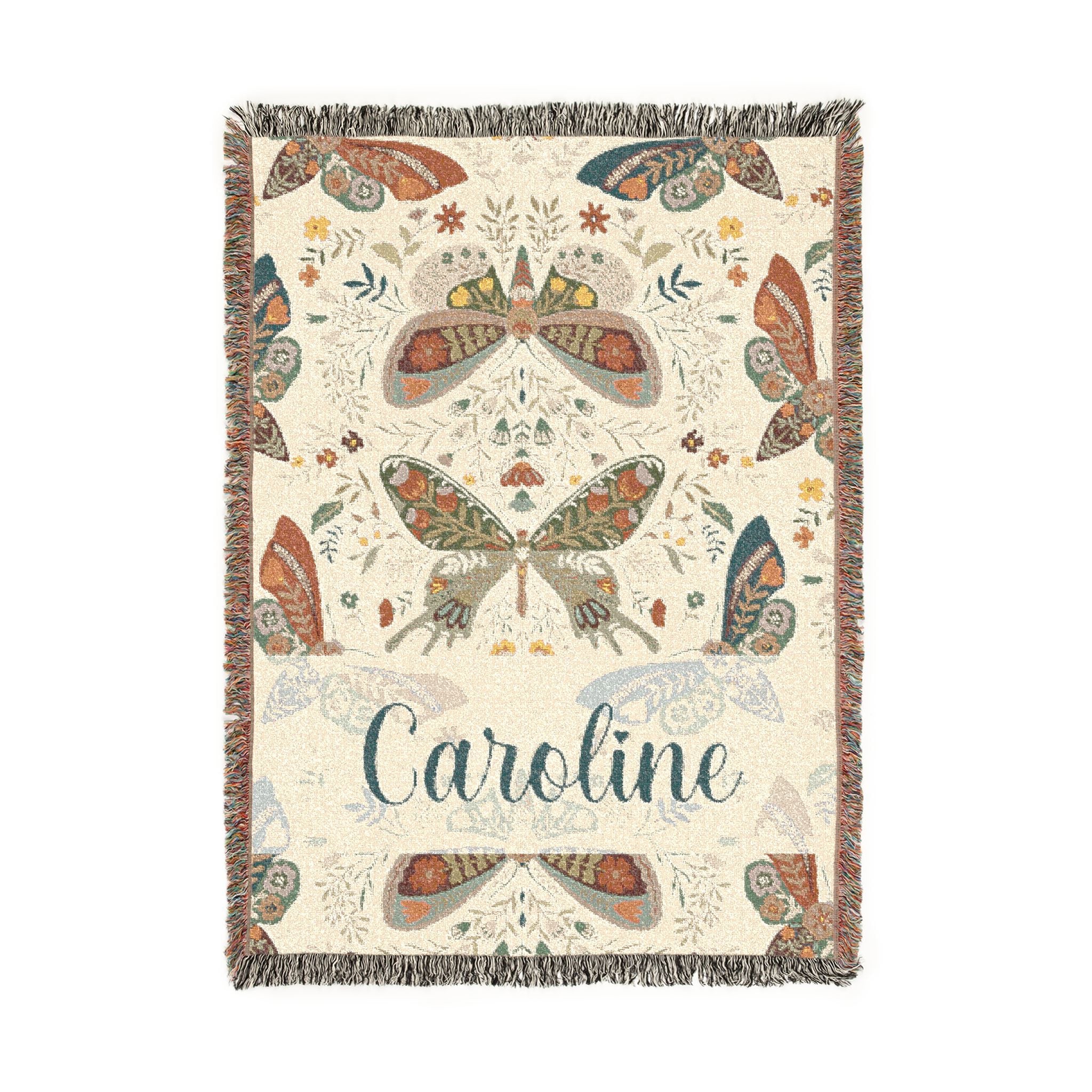 Decorative blanket with butterfly patterns and the name 'Caroline' on a white background