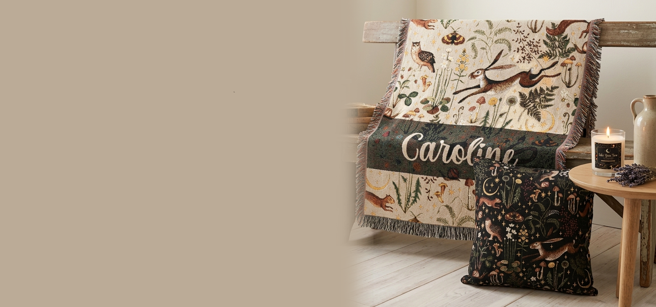 Decorative blanket with nature-themed pattern and text 'Caroline' on a wooden surface.