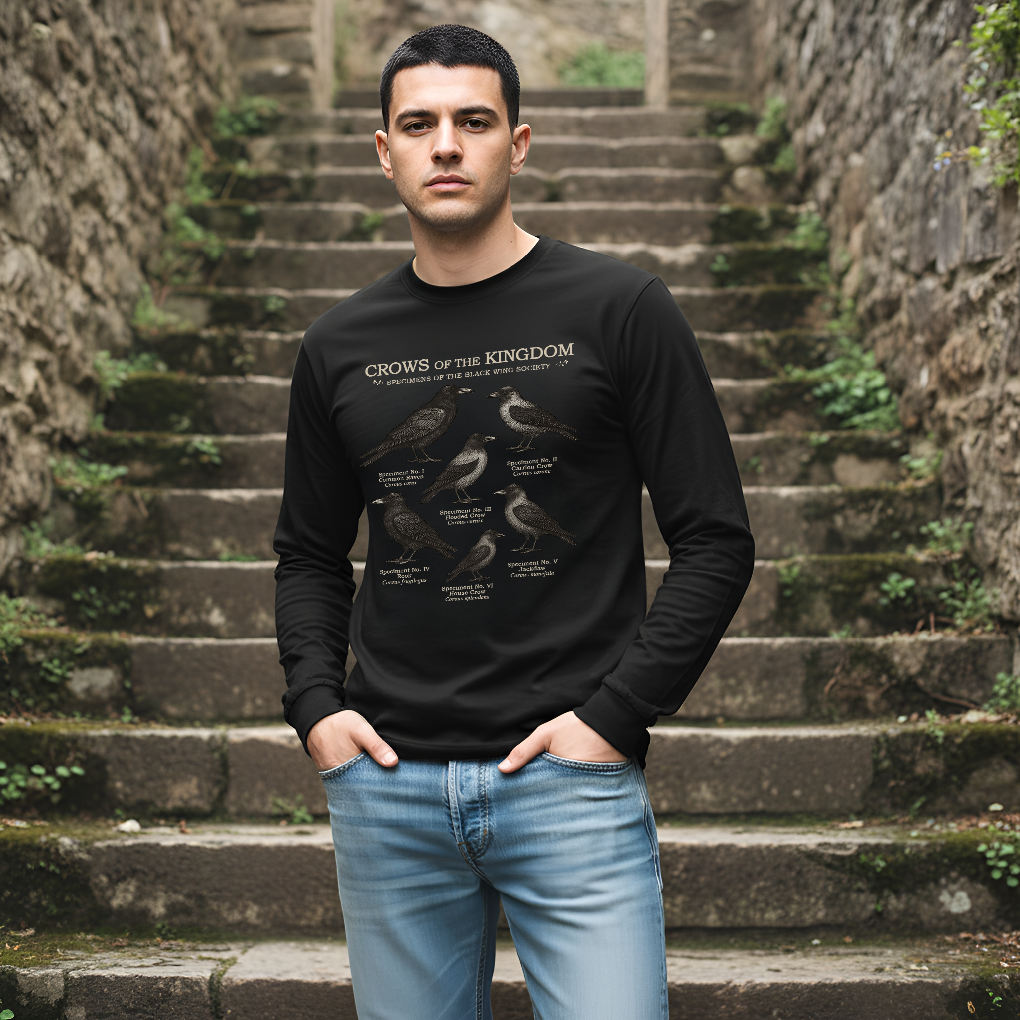Man wearing a black sweatshirt with text and graphics on stone steps