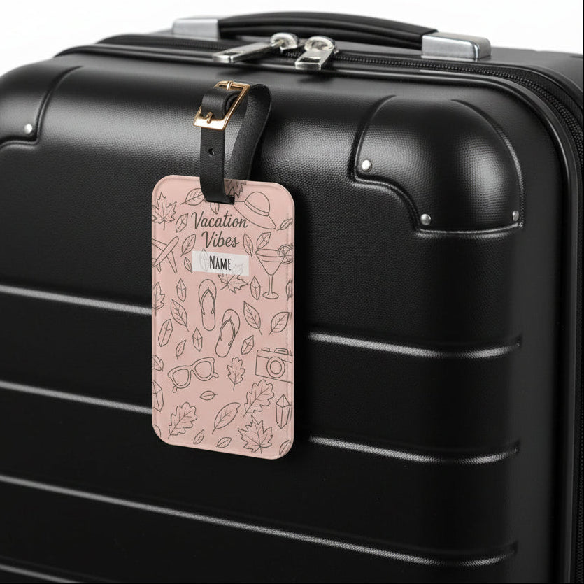 Pink luggage tag with 'Vacation Vibes' text and travel-themed illustrations on a white background