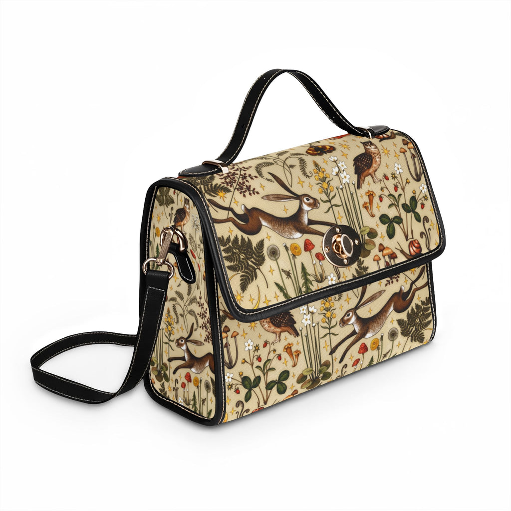 Handbag with woodland-themed design featuring animals and plants on a white background